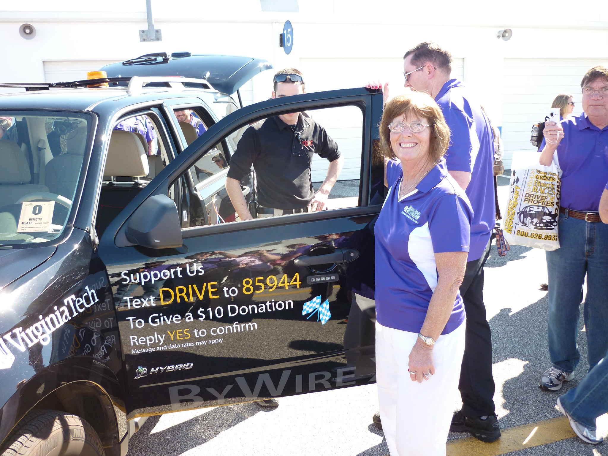Cathy Jackson holding the door of an SUV challenge vehicle